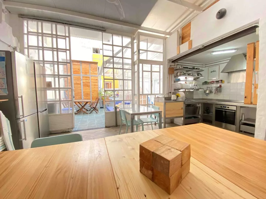 Coworking area and view of the terrace in EcoIsleta Coliving in Gran Canaria, desk to work remotly and view of the kitchen